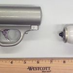 A New York woman was stopped by the TSA today at about noon as she was passing through a checkpoint at LaGuardia Airport after an officer spotted an unusual gun in the womanâs carry-on bag. "After closer inspection by both TSA officials and the Port Authority Police Department, it was determined that the item was a pepper spray/mace canister gun," says TSA spokesperson Lisa Farbstein. "The passenger voluntarily surrendered the item and she was cleared to catch her flight to St. Louis."
